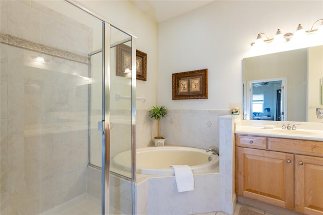 full bathroom featuring vanity, a garden tub, and a shower stall