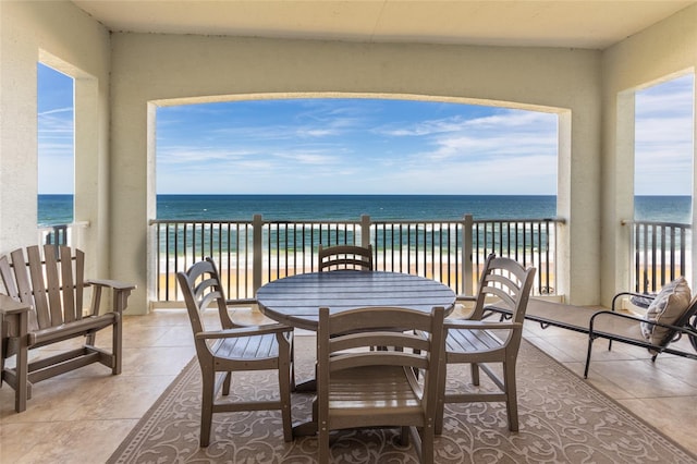 balcony with a water view and a beach view