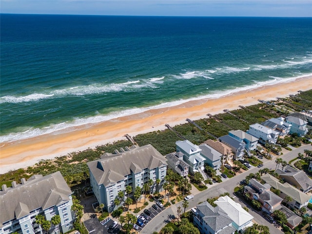 aerial view with a water view and a beach view