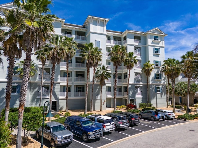 view of building exterior with uncovered parking