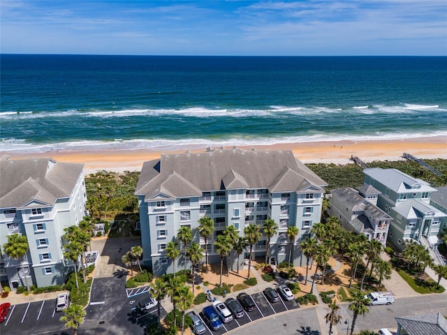 aerial view with a water view and a beach view