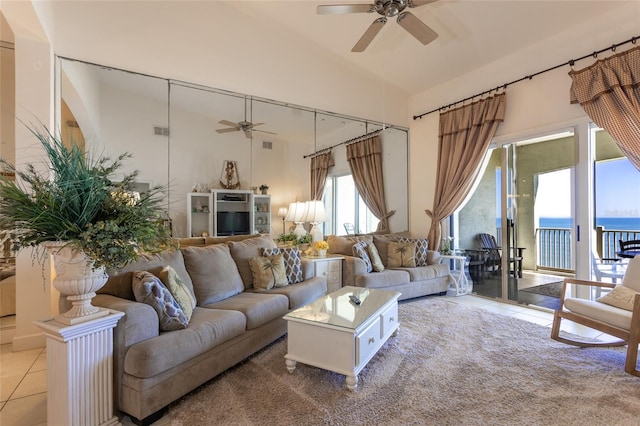 living room featuring tile patterned floors, high vaulted ceiling, and a ceiling fan