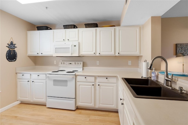 kitchen with light hardwood / wood-style flooring, white cabinets, white appliances, and sink