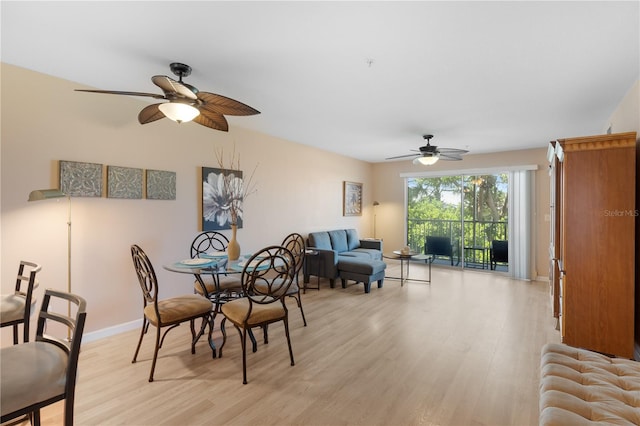 dining area with light wood-type flooring and ceiling fan