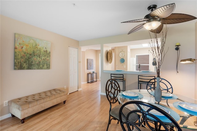 dining area featuring light wood-type flooring and ceiling fan