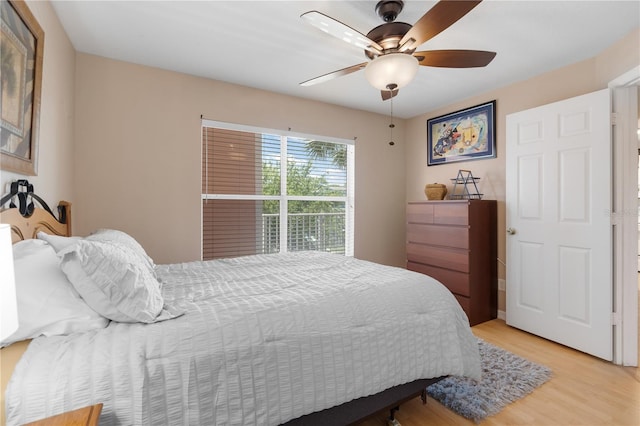 bedroom with light wood-type flooring and ceiling fan