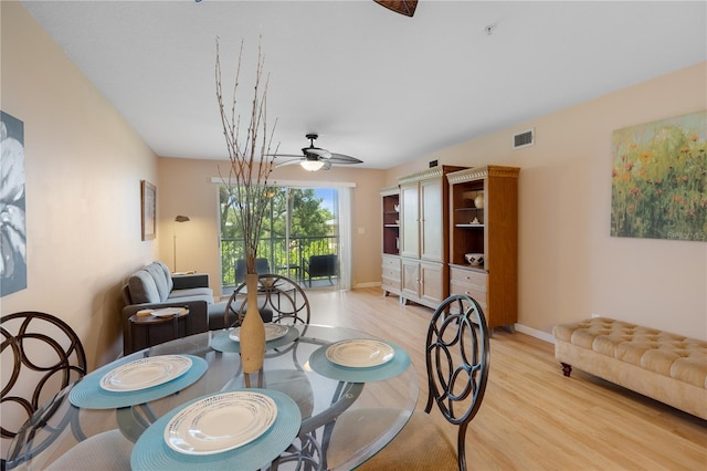 dining area with light hardwood / wood-style flooring and ceiling fan