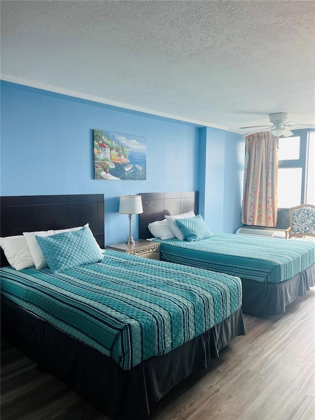 bedroom with a textured ceiling and light hardwood / wood-style flooring