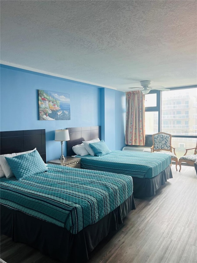 bedroom featuring a textured ceiling and wood-type flooring