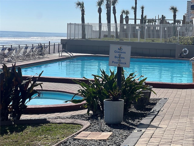 view of swimming pool featuring a water view