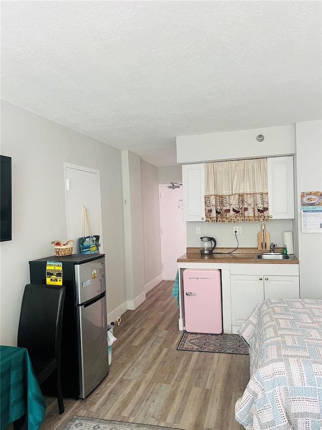 kitchen featuring white cabinets and light hardwood / wood-style flooring