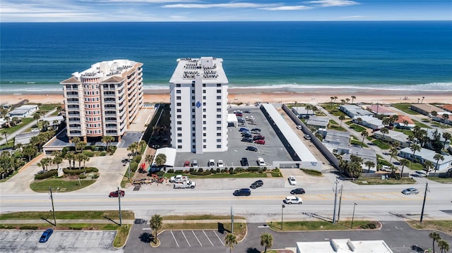 bird's eye view featuring a water view and a beach view