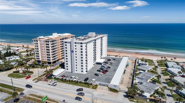 birds eye view of property featuring a view of the beach and a water view