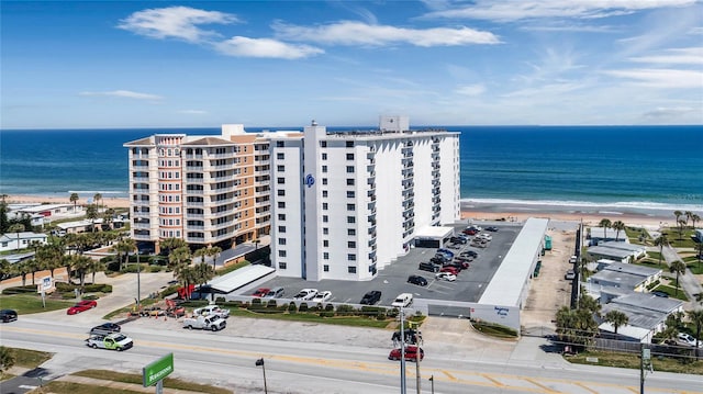 drone / aerial view with a water view and a beach view