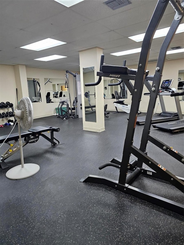 workout area with a paneled ceiling