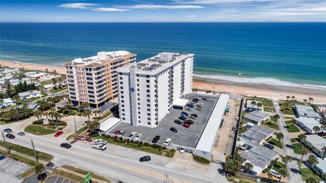 bird's eye view featuring a water view and a beach view