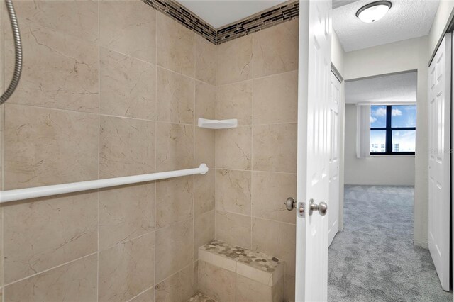 bathroom with a textured ceiling and walk in shower