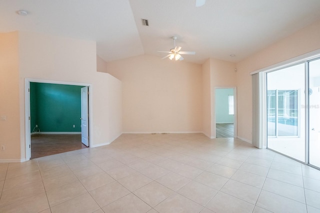 unfurnished room with ceiling fan, light tile patterned floors, and vaulted ceiling