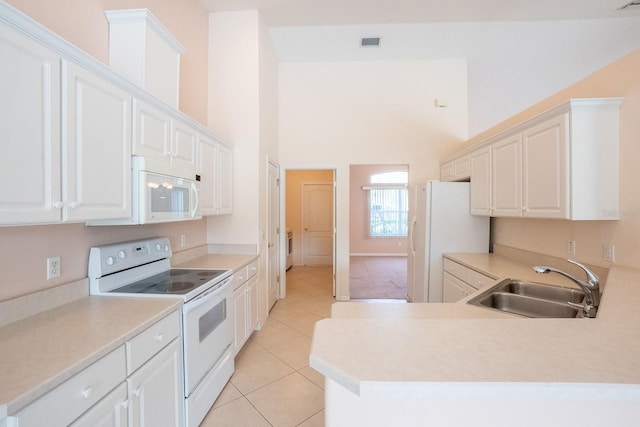 kitchen with white cabinetry, light tile patterned floors, white appliances, and sink