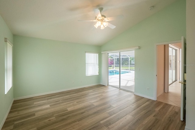 spare room featuring high vaulted ceiling, hardwood / wood-style floors, and ceiling fan