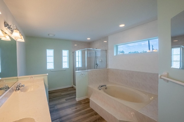 bathroom featuring vanity, wood-type flooring, and independent shower and bath