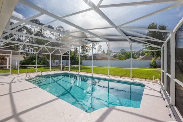 view of pool with a lawn, a lanai, a shed, and a patio area