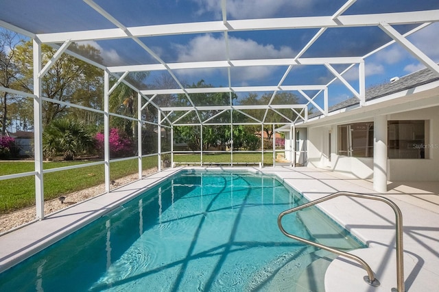 view of swimming pool featuring a lanai and a patio