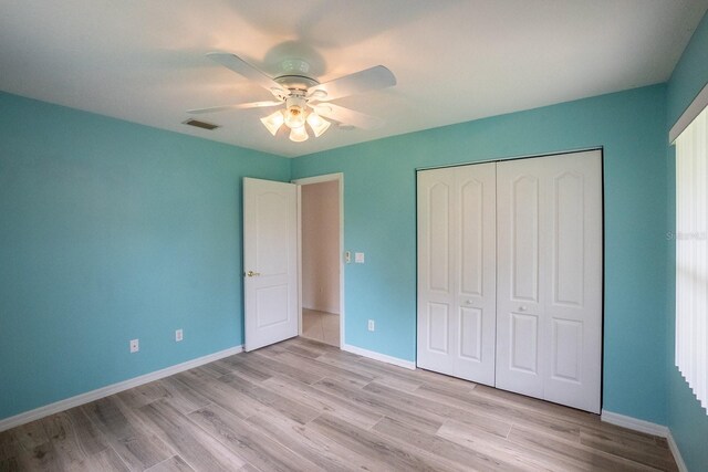 unfurnished bedroom with a closet, ceiling fan, and light hardwood / wood-style floors