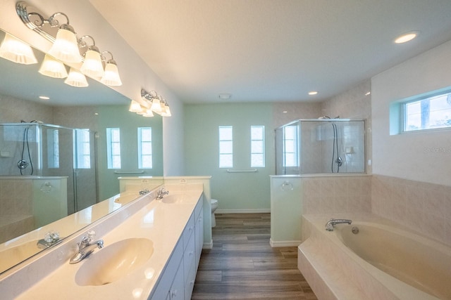 full bathroom featuring separate shower and tub, toilet, hardwood / wood-style floors, and vanity