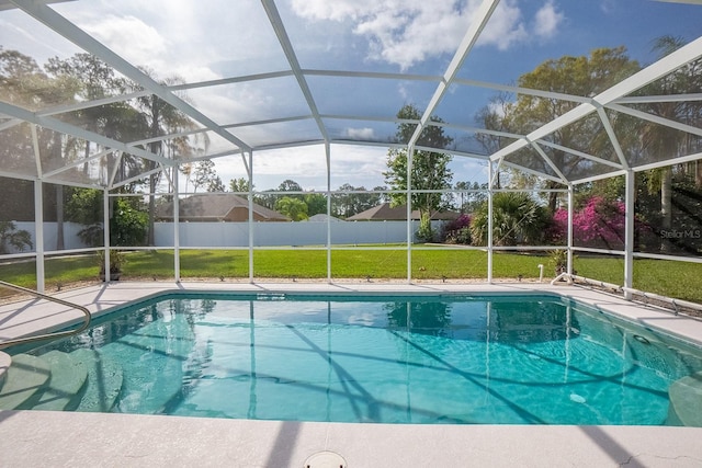 view of pool featuring a lawn and a lanai