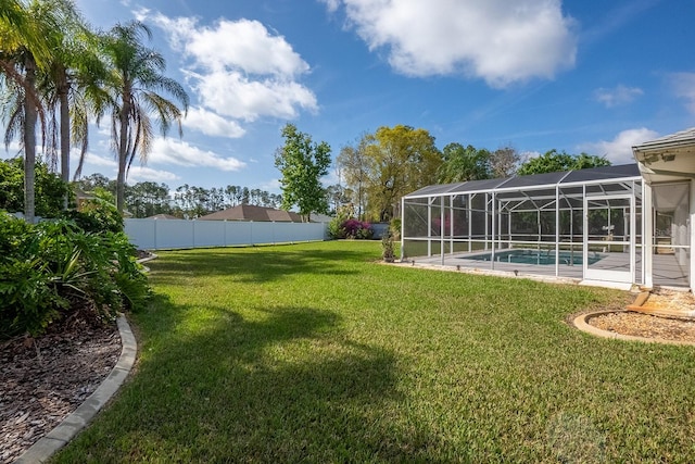 view of yard featuring a fenced in pool and a lanai