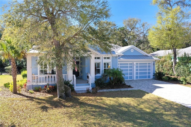 view of front of property with a front lawn, a porch, and a garage