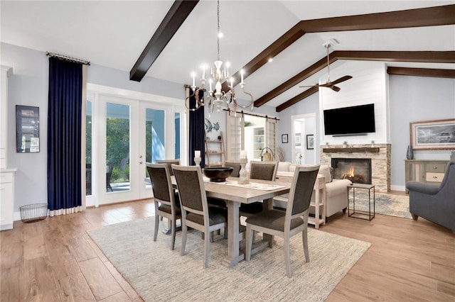 dining area with vaulted ceiling with beams, light wood-type flooring, french doors, and ceiling fan with notable chandelier