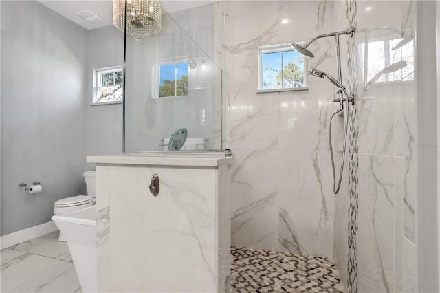 bathroom with toilet, a notable chandelier, and tiled shower