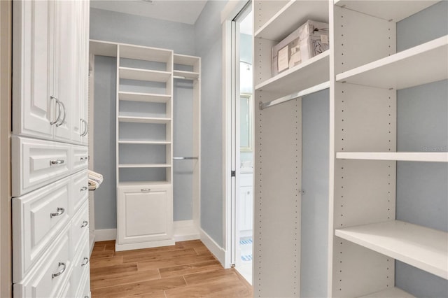 spacious closet with light hardwood / wood-style floors