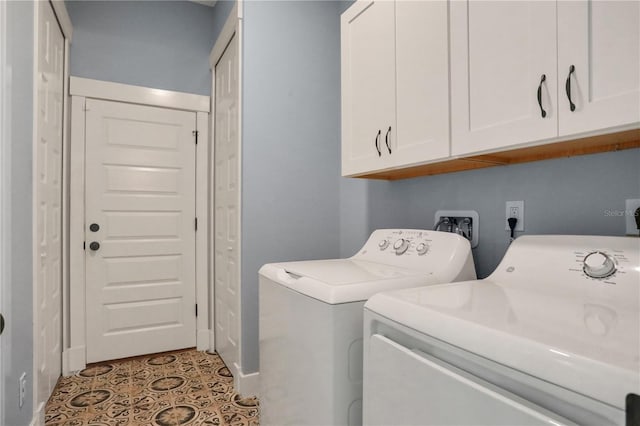 clothes washing area featuring light tile patterned floors, cabinets, and washer and clothes dryer