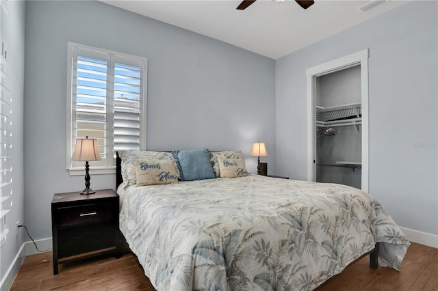 bedroom with ceiling fan, wood-type flooring, and a closet