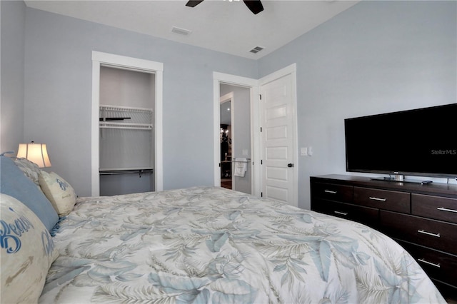 bedroom featuring ceiling fan, a walk in closet, and a closet