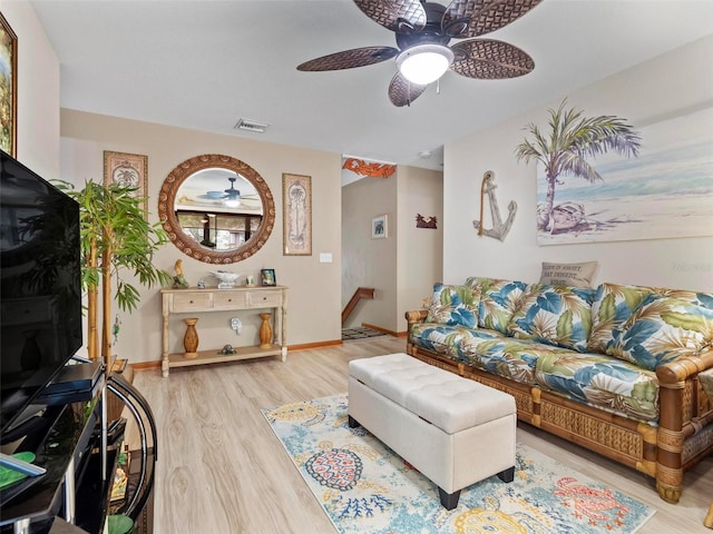 living room featuring light hardwood / wood-style floors and ceiling fan