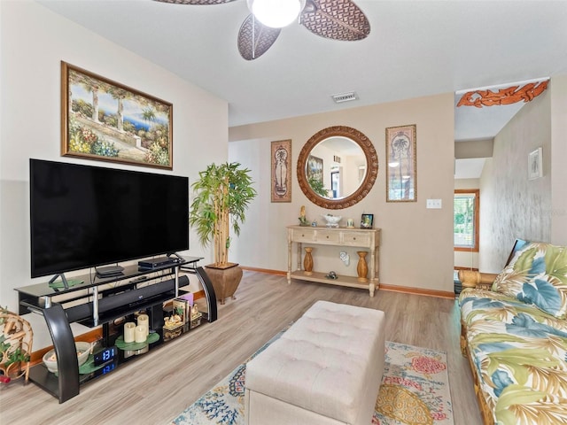 living room featuring light hardwood / wood-style floors and ceiling fan