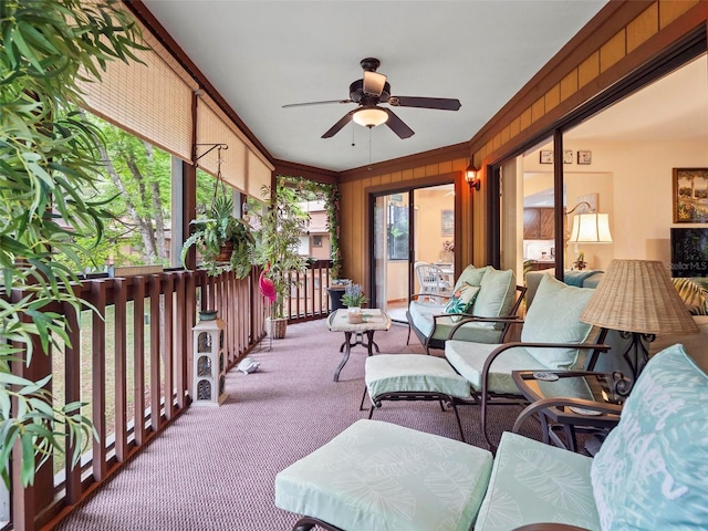 sunroom / solarium featuring ceiling fan