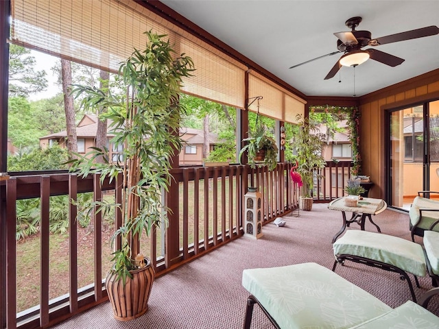 sunroom featuring ceiling fan