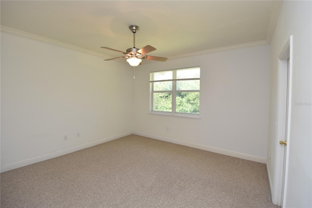 empty room featuring light colored carpet, ceiling fan, and crown molding