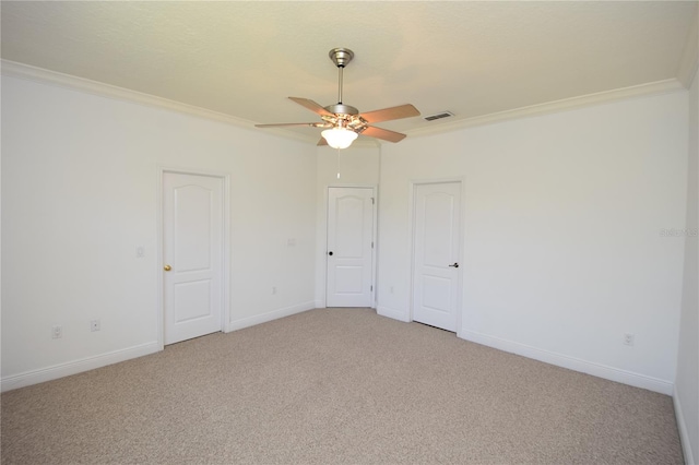 empty room with light carpet, ceiling fan, and ornamental molding