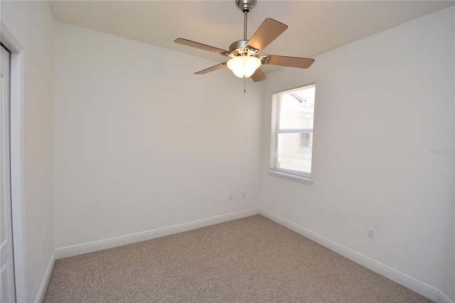 spare room with light colored carpet and ceiling fan