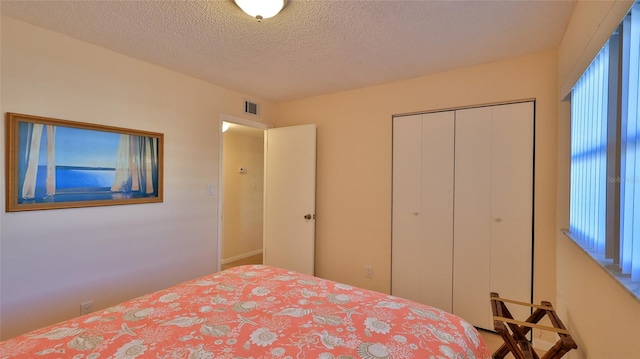 unfurnished bedroom featuring a closet, a textured ceiling, and multiple windows