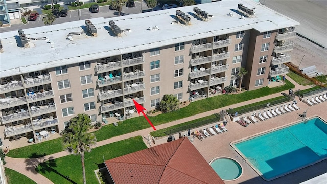 view of building exterior featuring a community pool