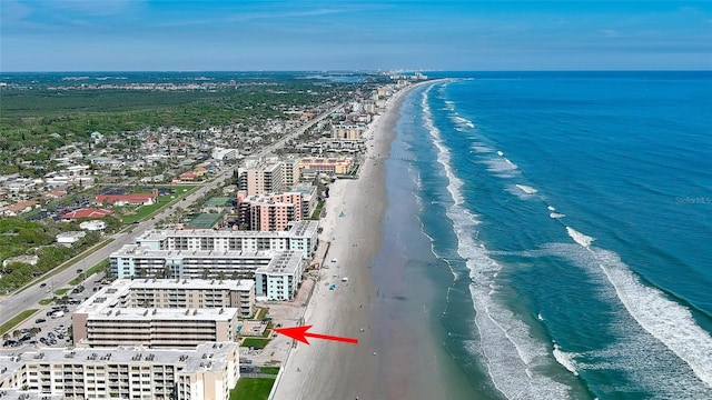 birds eye view of property featuring a beach view and a water view