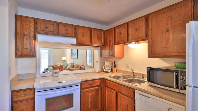 kitchen featuring white appliances and sink