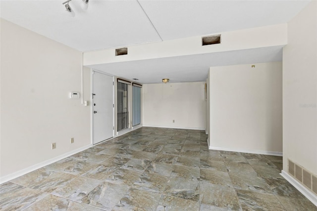 unfurnished room with tile floors